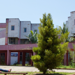 Foto aberta do campus, com o Centro de Convergência ao fundo e, no primeiro plano, estudantes sentados conversando